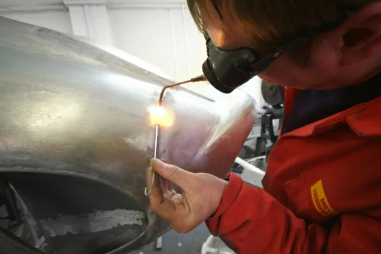 Ferrari 250 GTO rear end repair using traditional welding techniques.