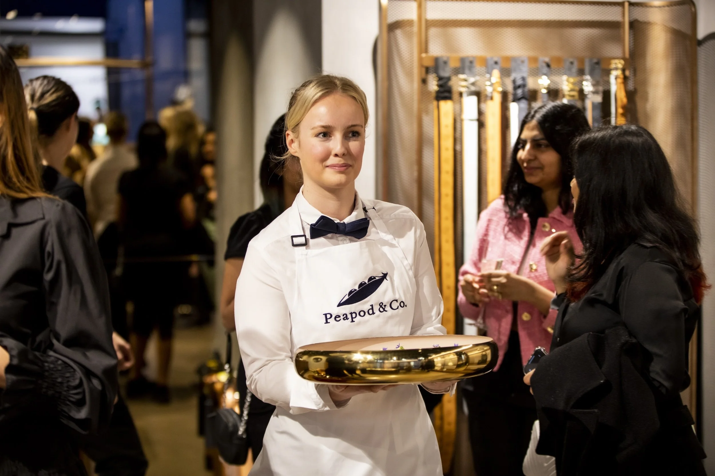 Peapod & Co. staff holding canapés in shop