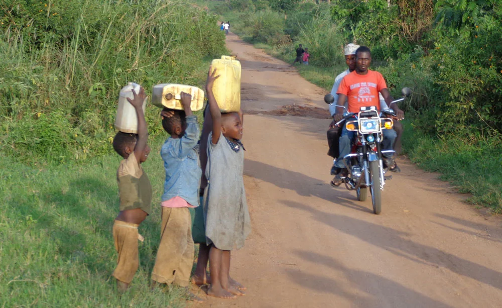 PIM-About-Kamwenge-kids-carrying-water.jpg