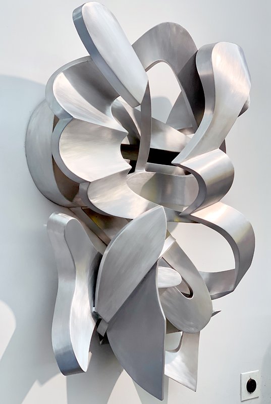  Metal sculptor Kevin Barrett is noted for creating unique, rhythmic, abstract indoor and outdoor sculpture in bronze, steel, and aluminum. 