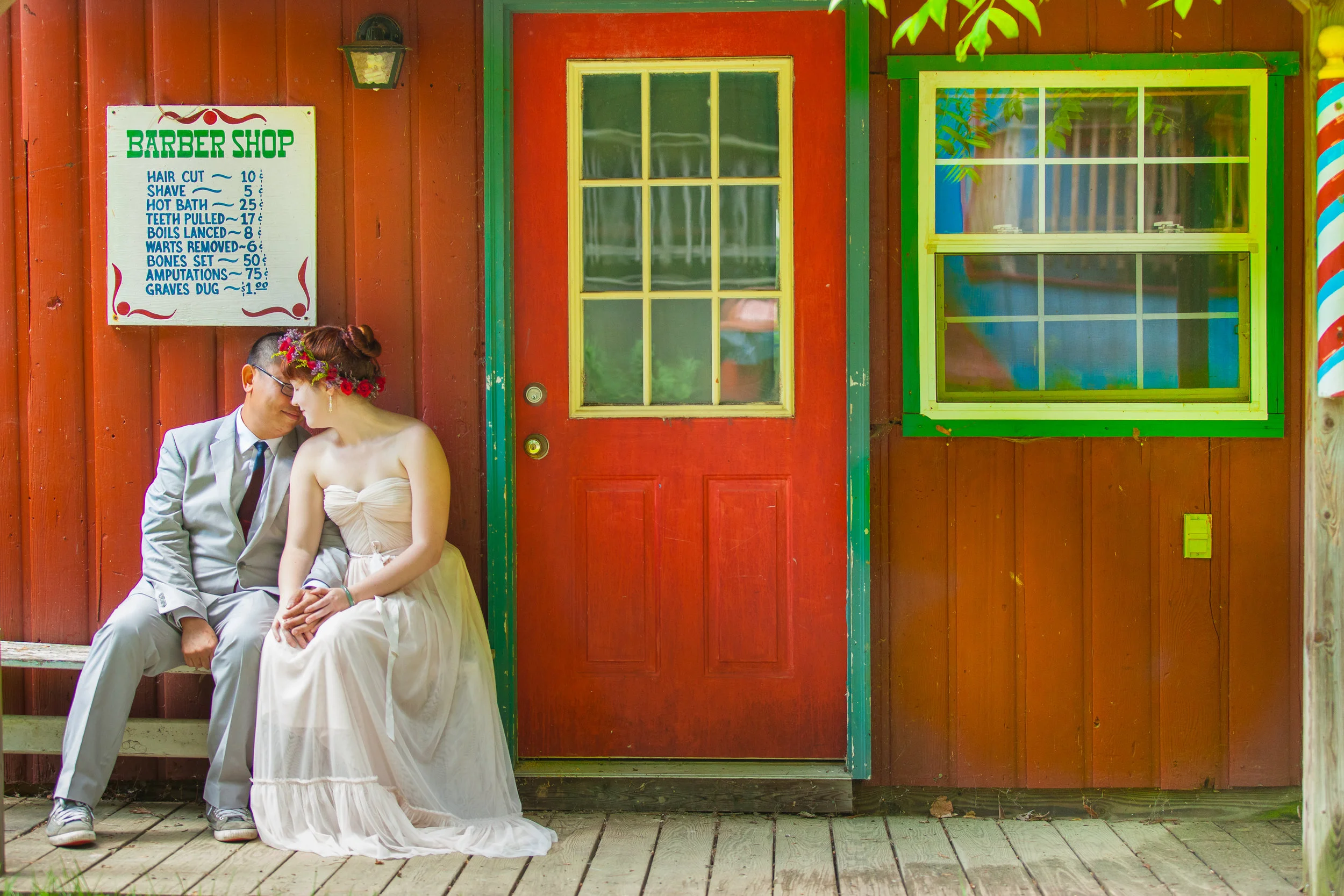 Bride & groom in front of red wall