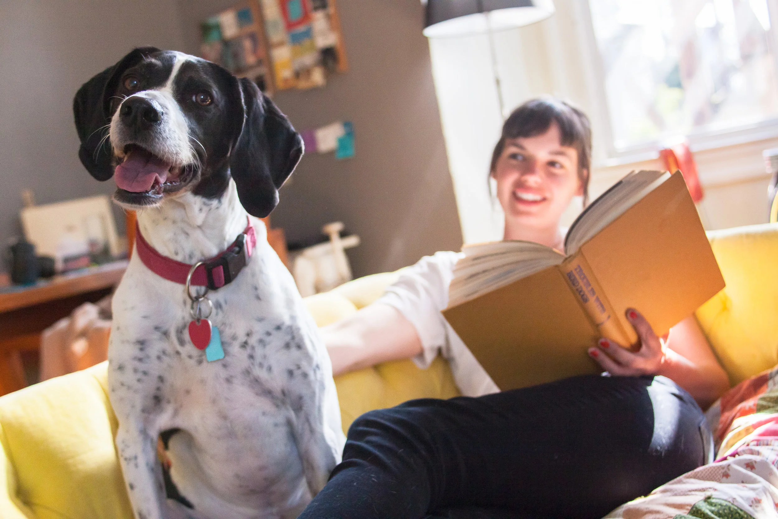 Young woman on couch with dog
