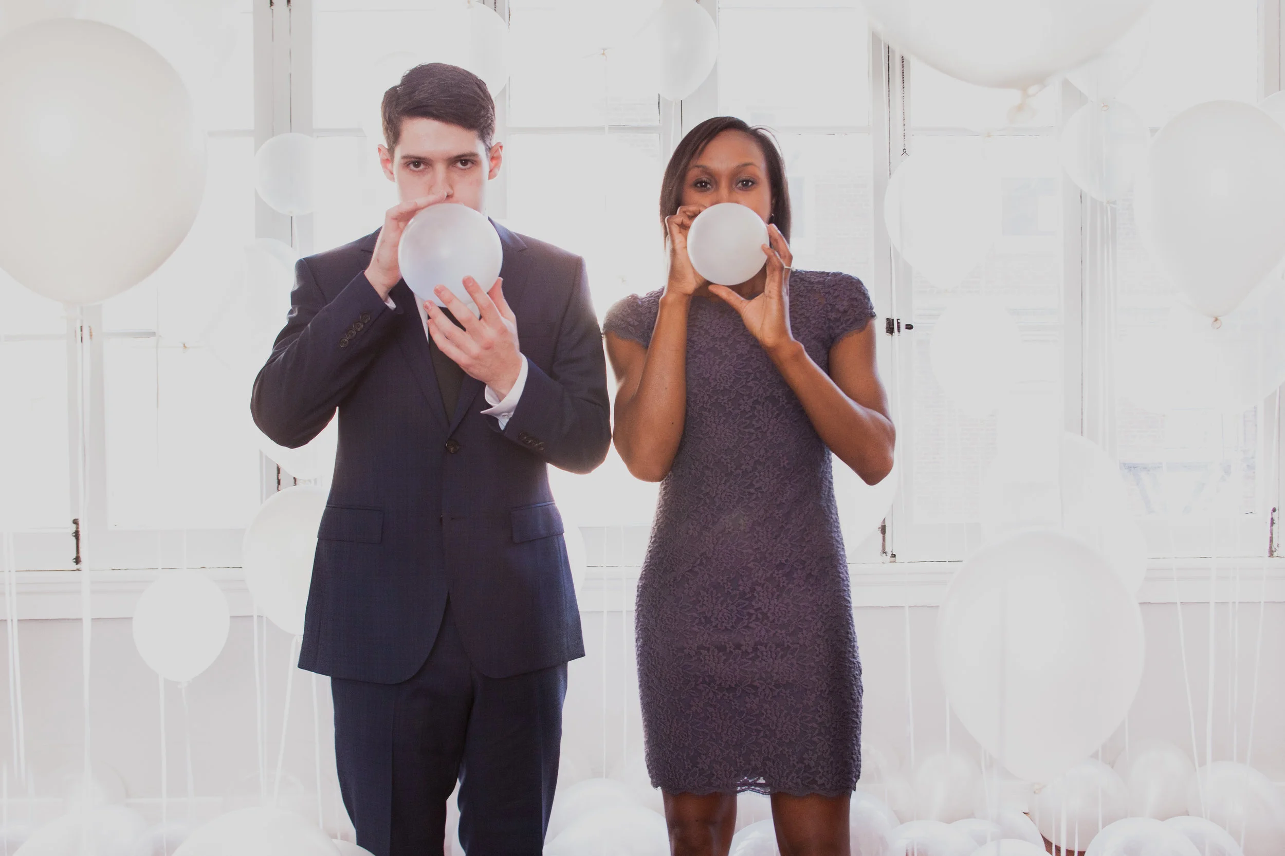Man & woman blowing up balloons
