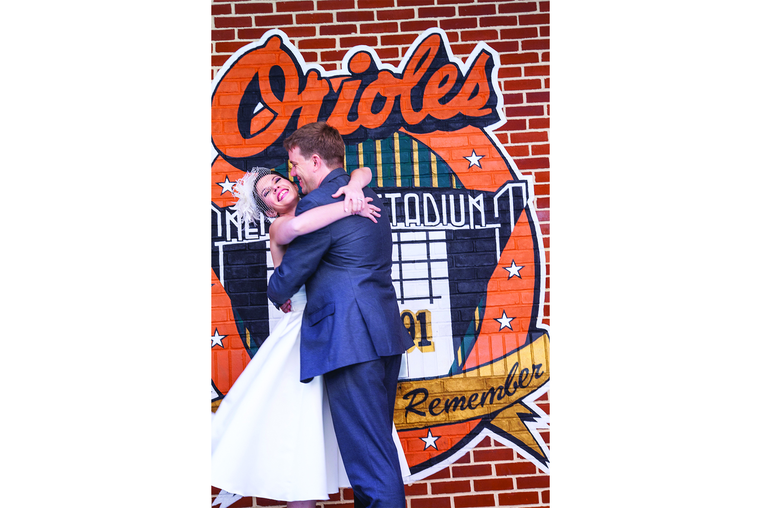 Bride and groom in front of Orioles wall