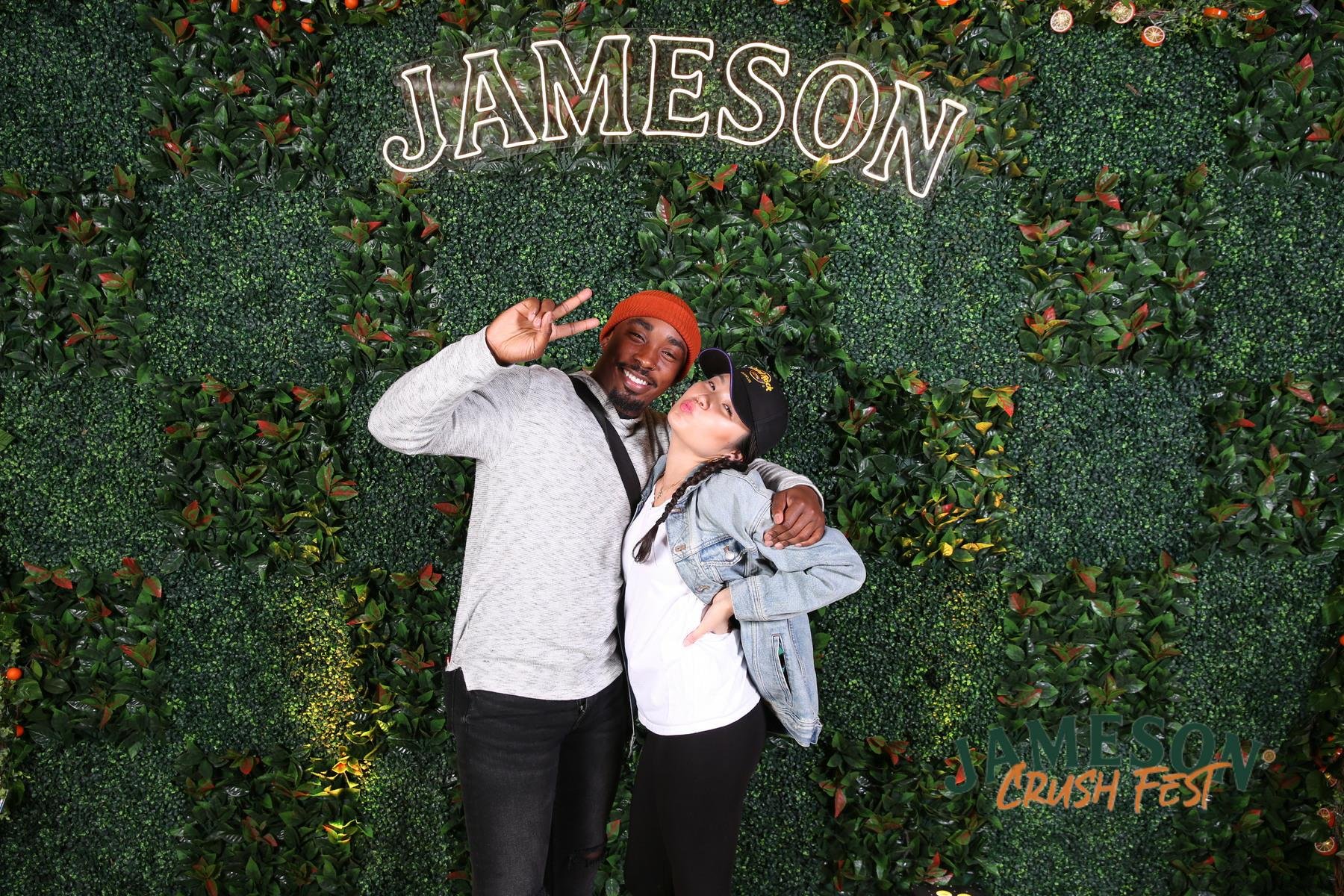 Smiling couple under Jameson sign