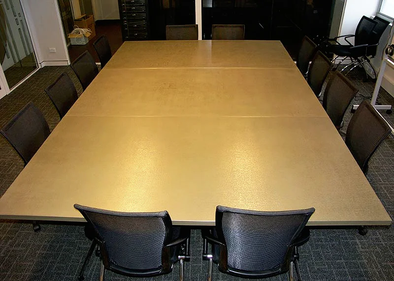 boardroom table in liqmet brass