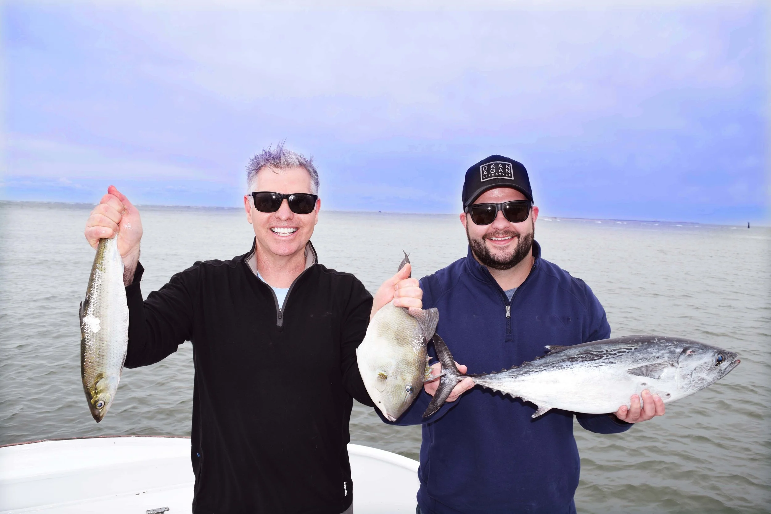 Travel writer Steve MacNaull and his son, Alex, show off part of their catch after fishing with The Albatross Fleet in the Pamlico Sound off North Carolina's Outer Banks.