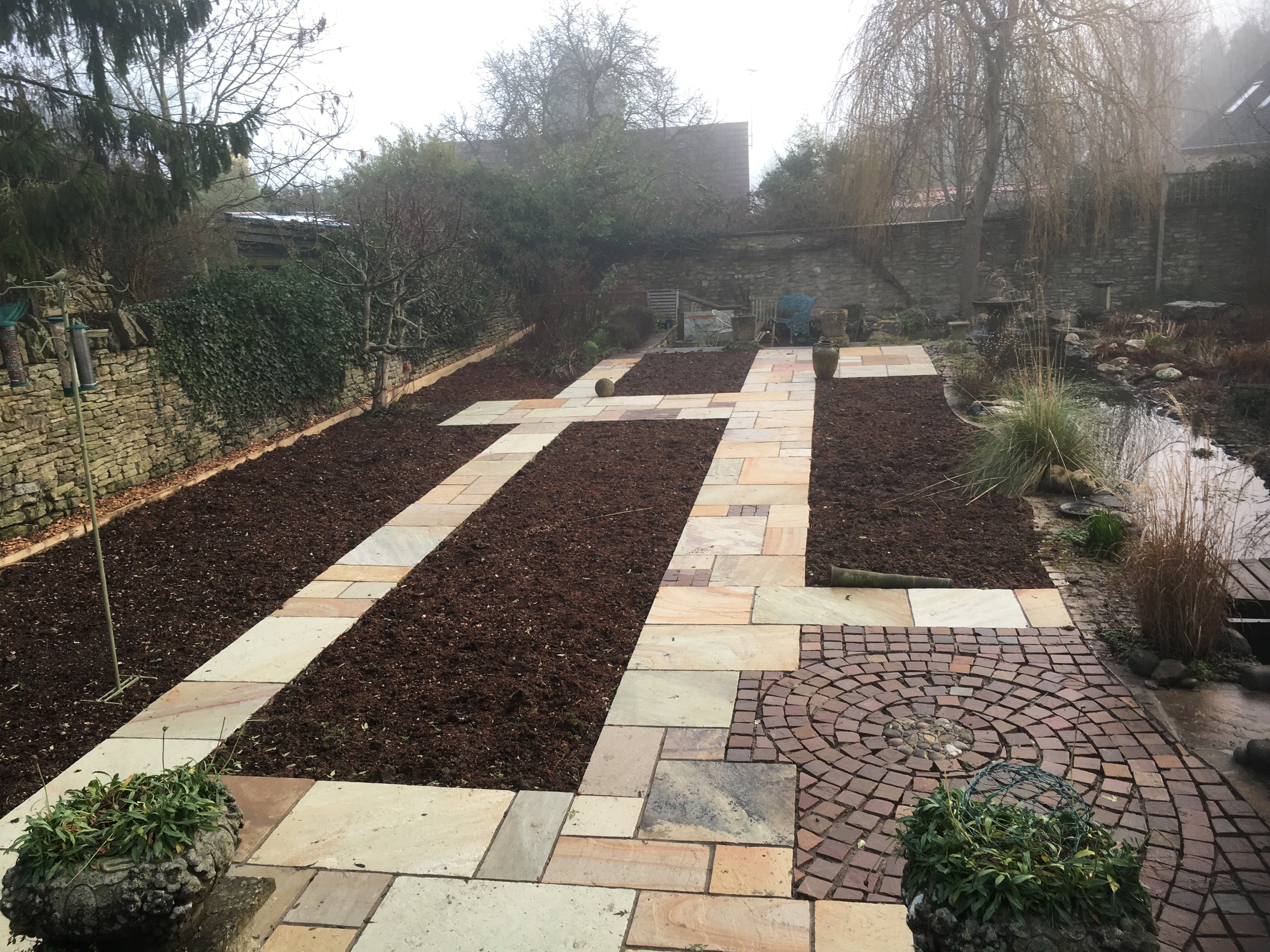 Looking directly down the entrance steps to the garden following the finish of the initial landscaping prior to planting and construction of the colonnade.
