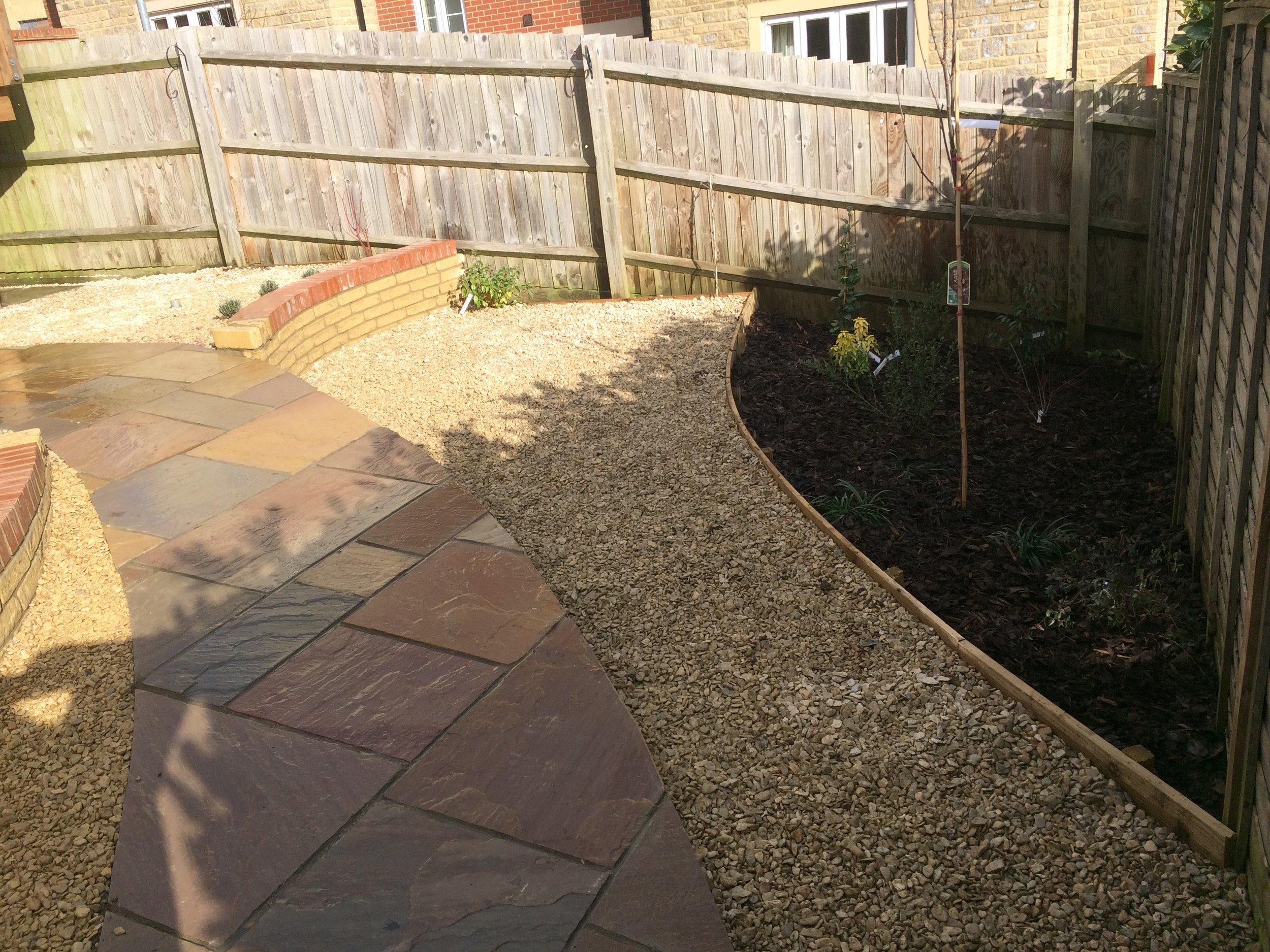 A reasonable-sized border allows for the planting of a tree and numerous shrubs to soften the overall scheme.