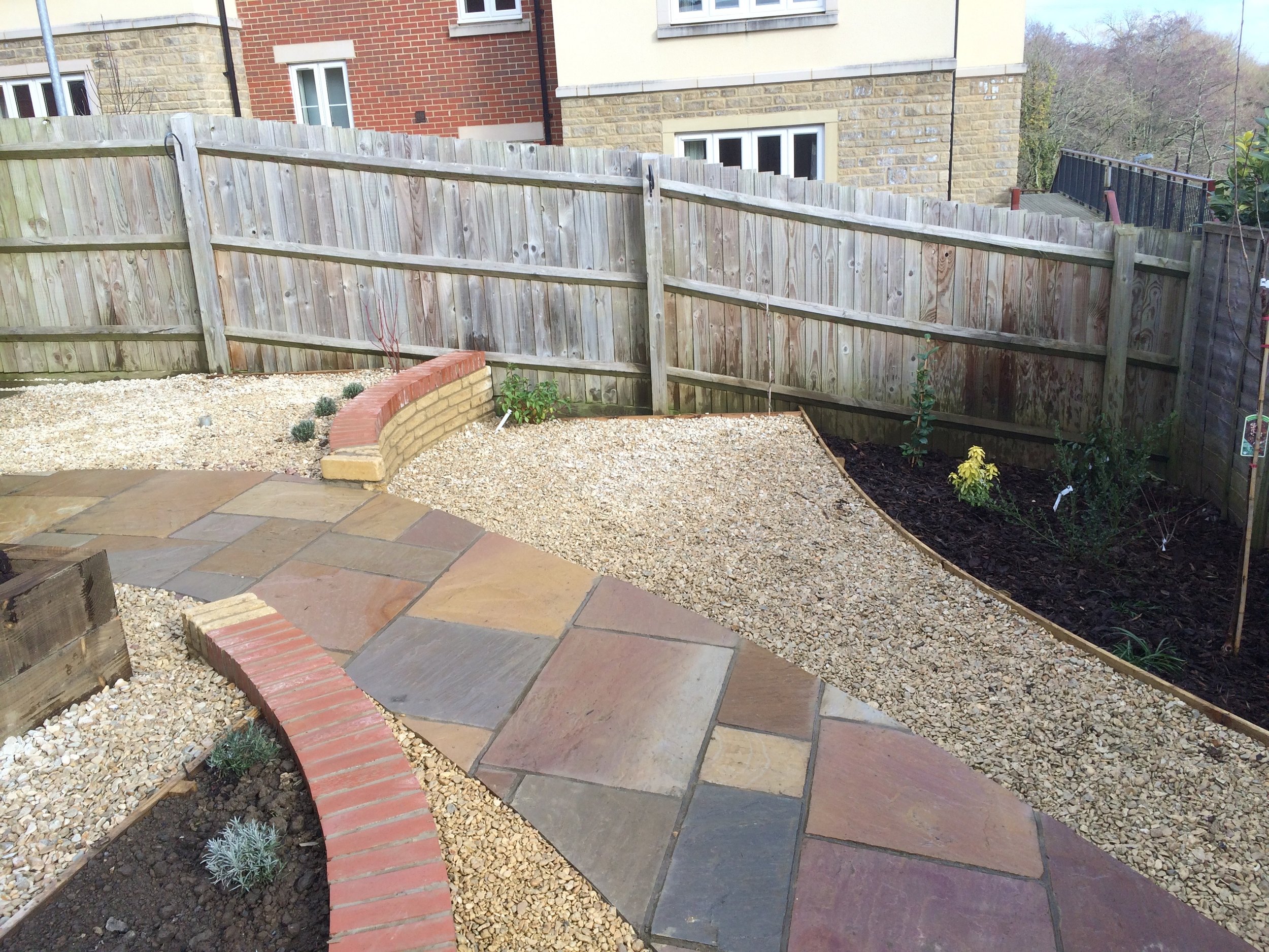 The brief was for a low maintenance garden, with some manageable growing space that dealt with the sloping access without needing steps.