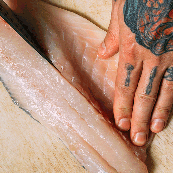 Moving image of a chef slicing fish and preparing seafood.