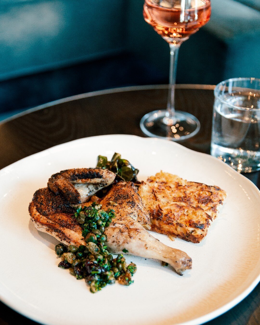 Experience a fusion of exquisite flavors with our Roasted Half Chicken. Delight in the tender chicken, perfectly complemented by the crispy bacon collard greens and the rich and buttery confit garlic potato cake. Elevating the dish to new heights, ou
