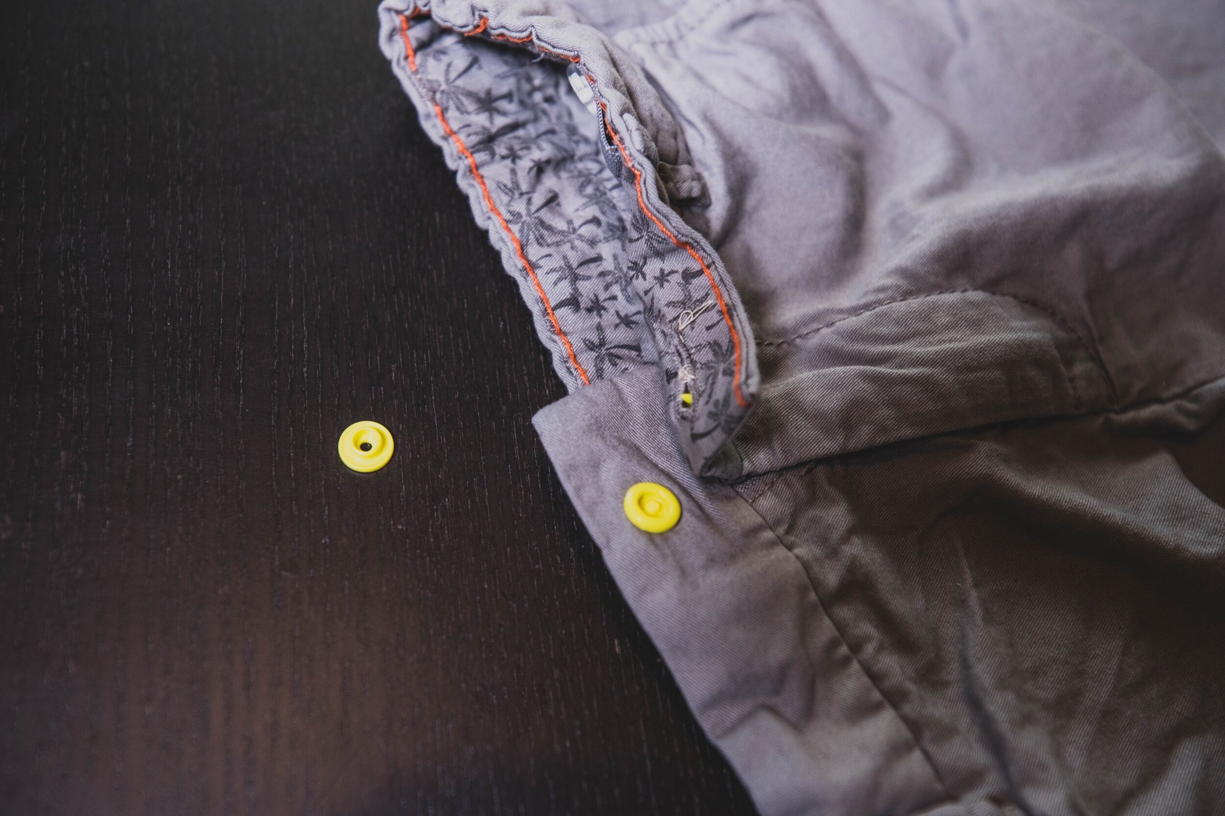slide base of the snap into the hole of the button slit that you didn’t sew up.