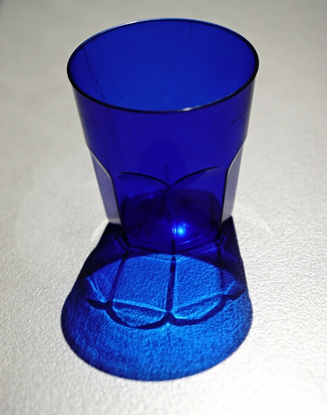 You will often see sommeliers using tasting glasses - small blue glasses.