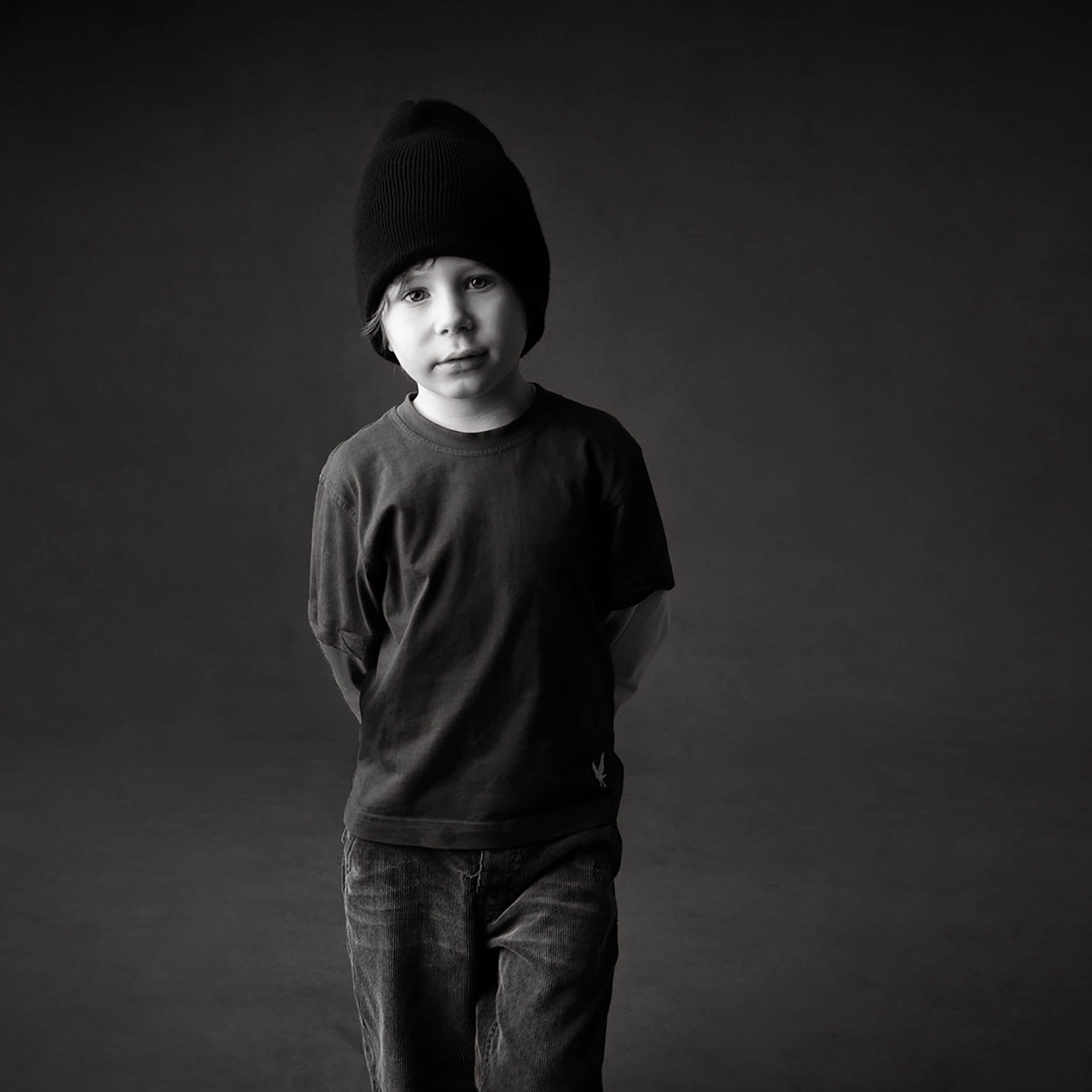 young-boy-black-hat-dark-photo-studio-background-sq.JPG