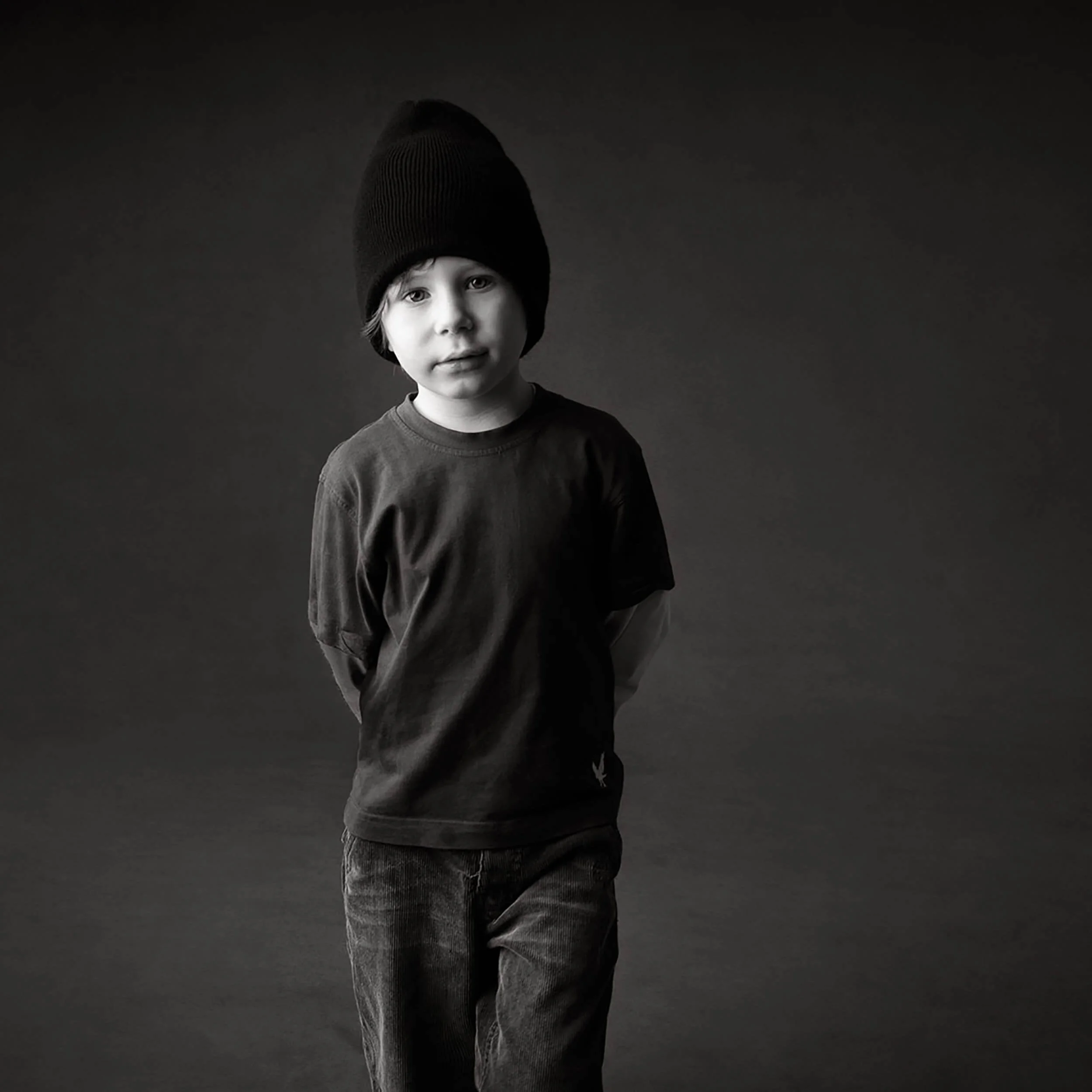 young-boy-black-hat-dark-photo-studio-background-sq.JPG