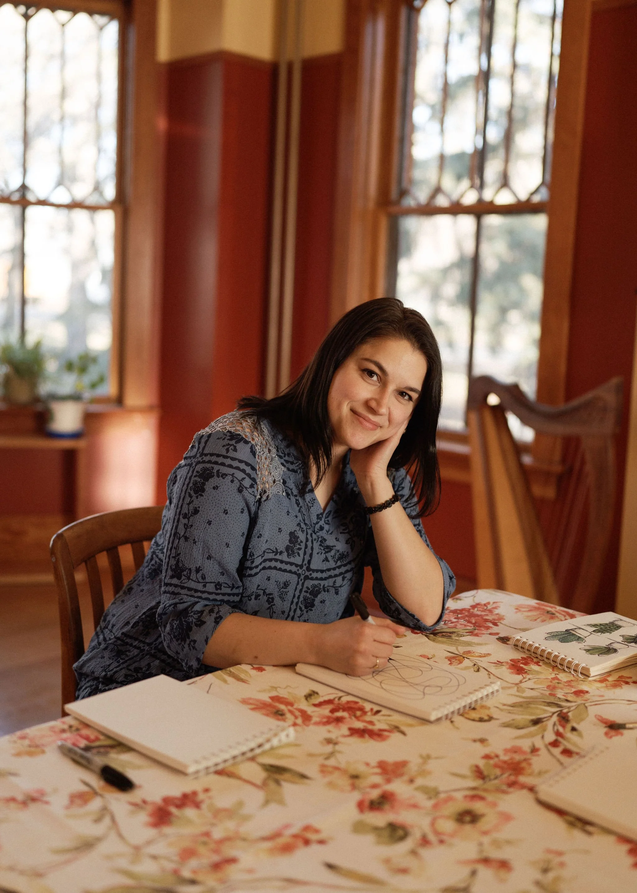Art therapist sitting at table enjoying making art