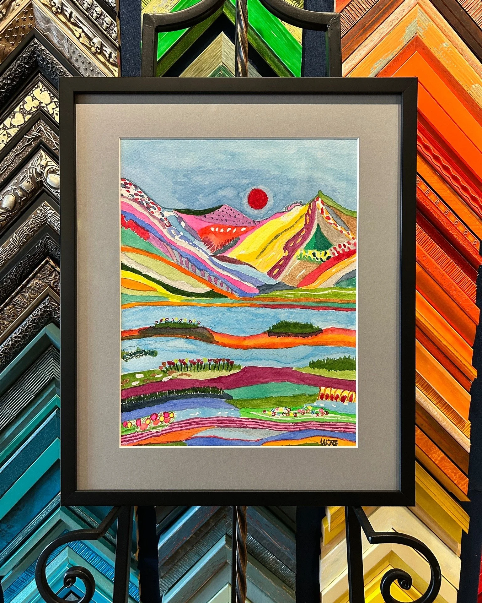This colorful landscape was painted by our customer and local artist, William Gallogly, for his goddaughter. We just love the use of color and pattern to create this amazing landscape. Something with this much going on looks great in a simple black f