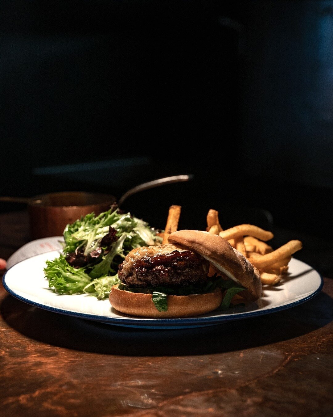 Burger maison, frites. House ground beef, caramelized onions, raclette cheese, fries, salad.⁠
⁠
Available during weekday lunch and weekend brunch -- until 5 pm.