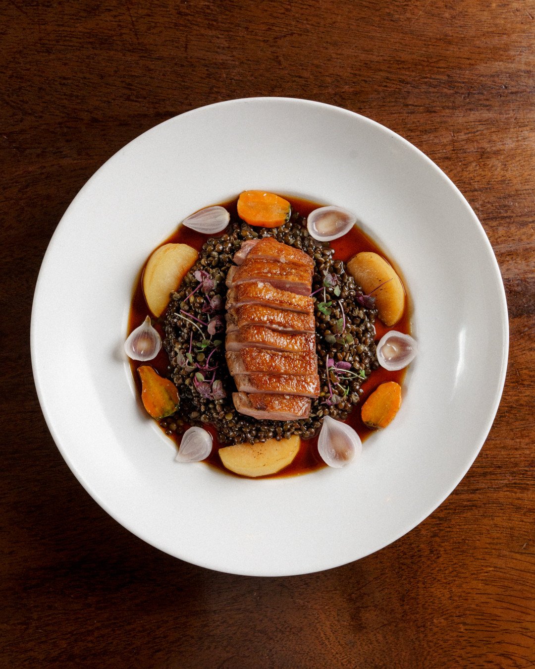 Magret de Canard | verjus glazed duck breast, lentils, carrots, pickled pearl onion, plum, duck jus⁠
⁠
Verjus is unripe grape juice, tart without the harshness of vinegar. When you glaze duck breast with it, you get a delicate sweet-sour balance that