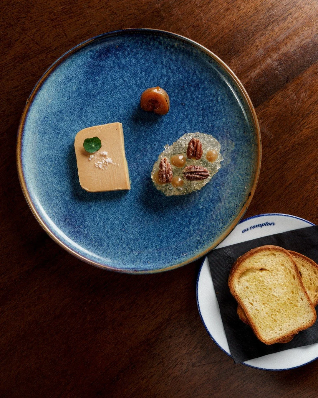 Foie Gras | duck foie gras terrine, seasonal fruits, white wine jelly, house-made brioche⁠
⁠
Terrine refers to the cooking vessel, an earthenware dish with a tight lid where ingredients steam in their own juices. This technique gives foie gras its si