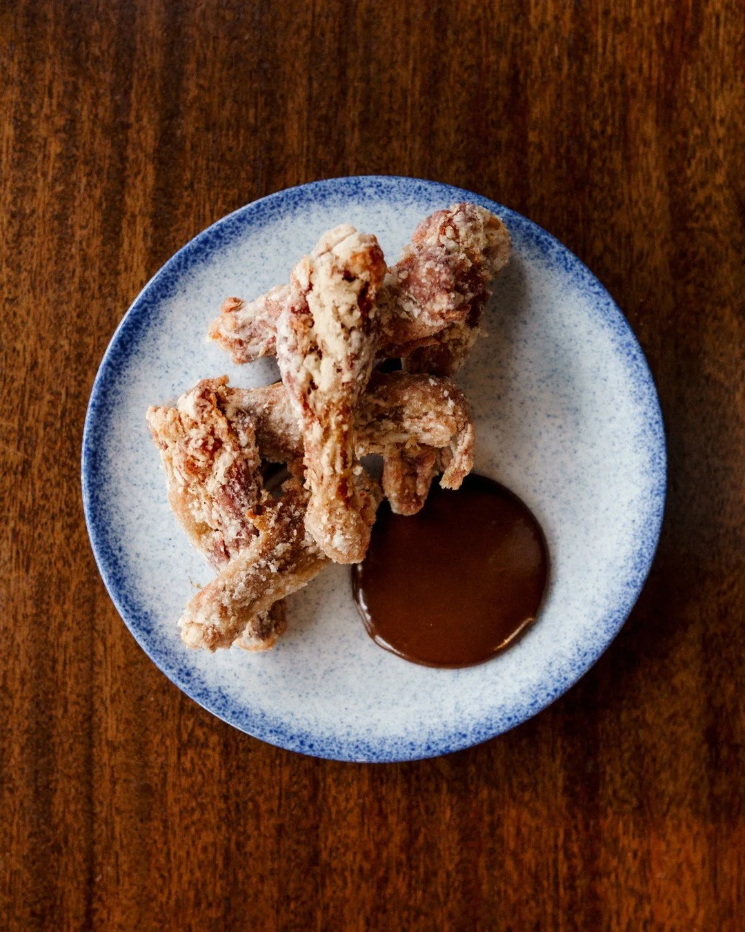 Manchons de Canard | half dozen crispy confit duck wings, black garlic pur&eacute;e⁠
⁠
Duck wings at brunch. Confit first so the meat stays tender and picks up all that duck fat flavour, then crisped to order. The skin gets properly crispy, the meat 