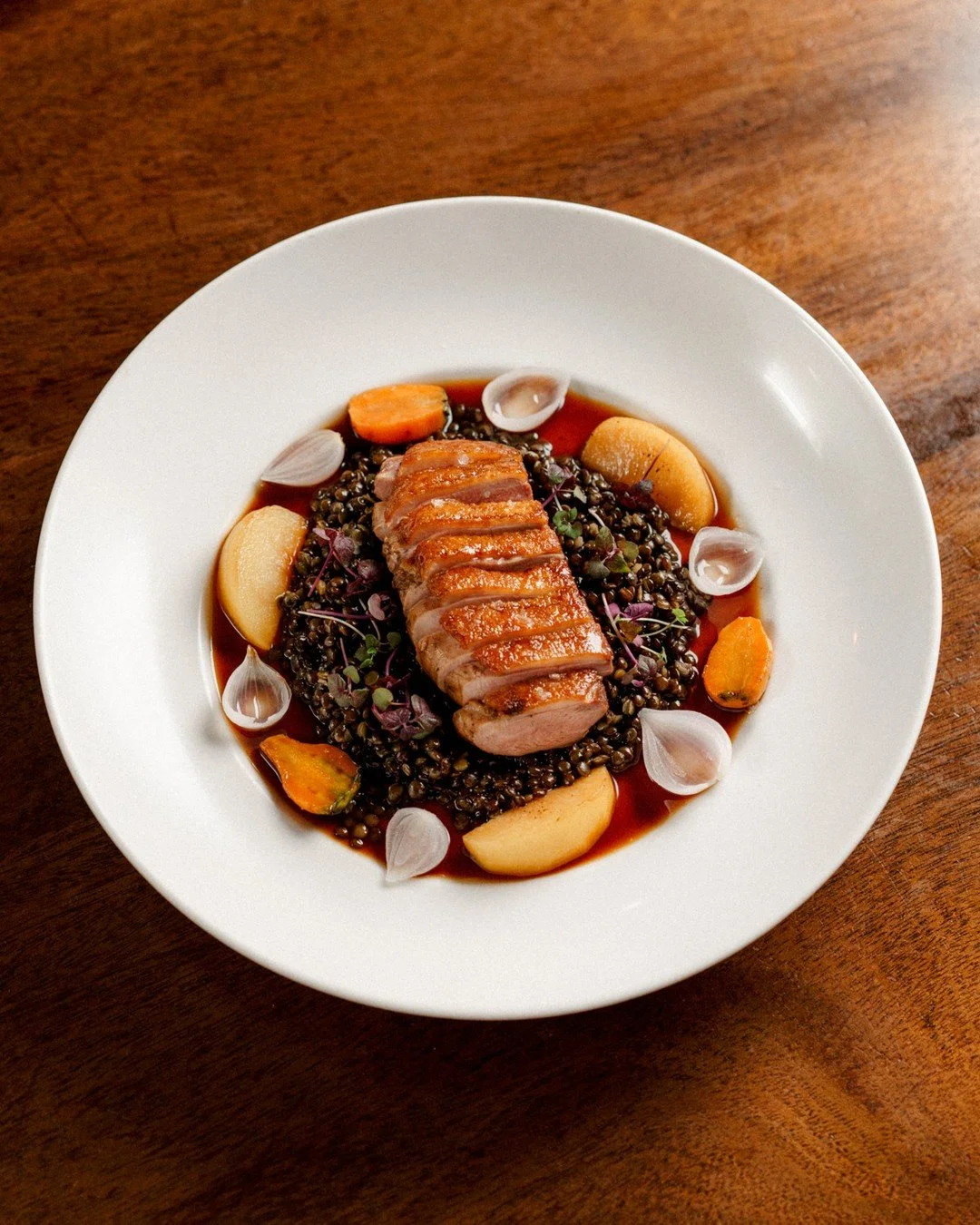 Magret de Canard | verjus glazed duck breast, lentils, carrots, pickled pearl onion, plum, duck jus⁠
⁠
Duck breast cooked medium rare, sliced thin, with lentils and roasted vegetables. The verjus glaze brings acidity without overpowering the meat. Pl