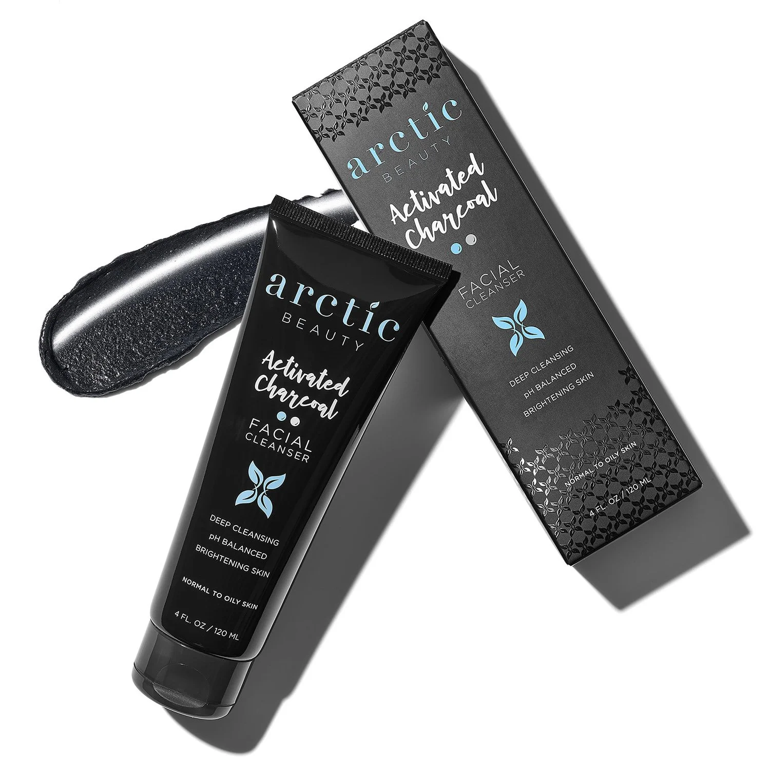 Tube of Arctic Beauty Activated Charcoal Facial Cleanser next to its box, with a black scrub or balm swatch alongside, on a white background.