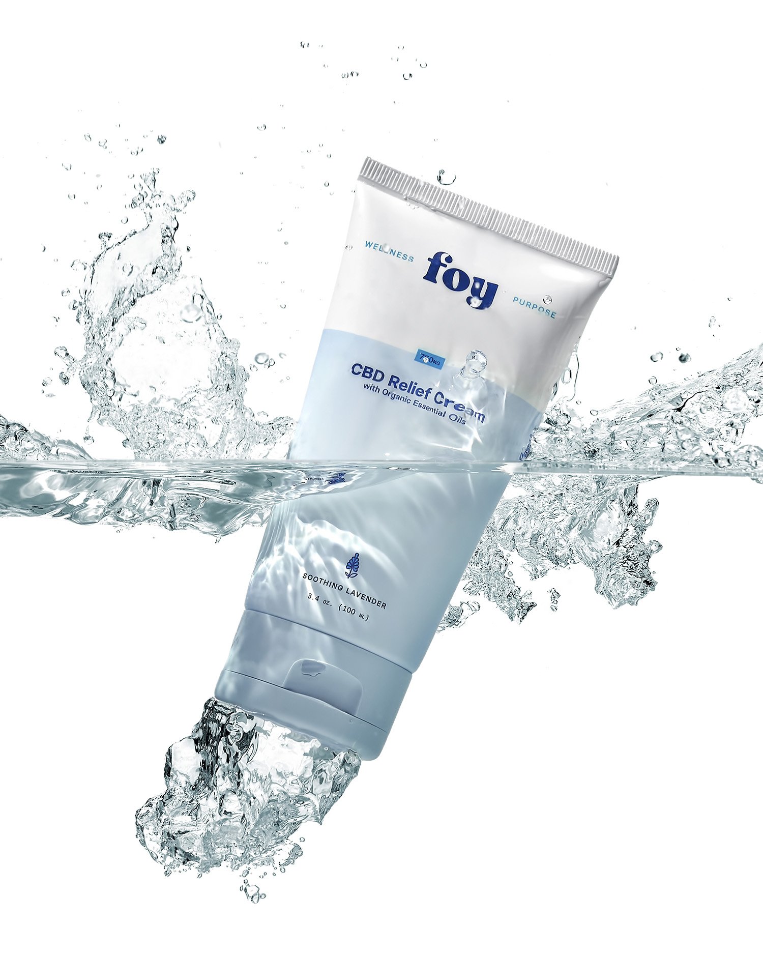 The image shows a tube of Foy CBD Relief Cream with Organic Essential Oils, labeled as Soothing Lavender, submerged in water with splashes.