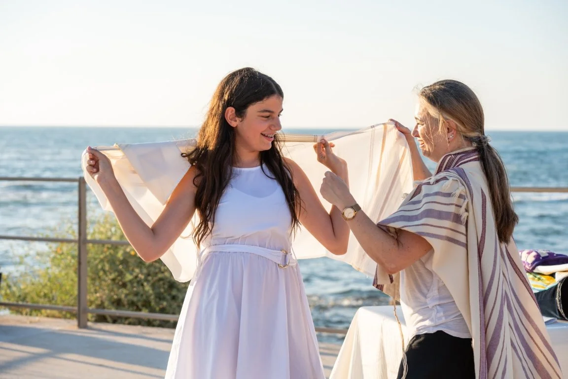 GIRL SND WOMAN RABBI NEAR THE SEA