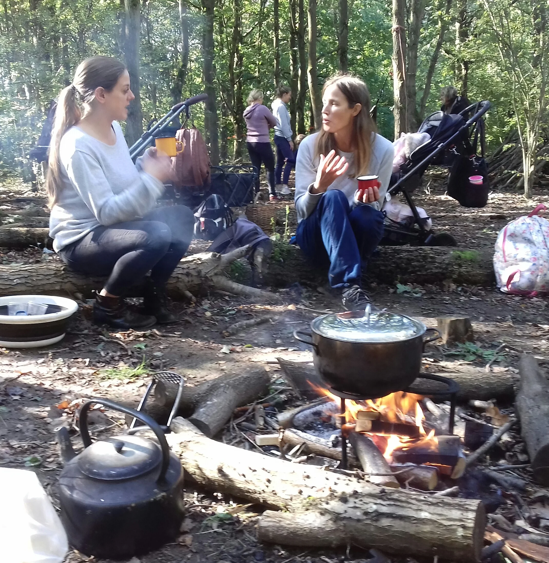Two mums, getting to know each other whilst their children play at Chanterelle, Highwoods, Colchester