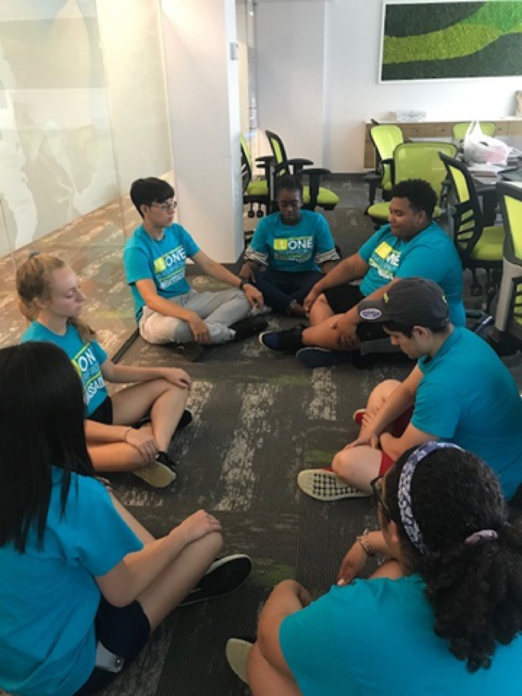  After a long day of work and fun, Ambassadors Assistant Program Manager Ashley takes the group through a few minutes of meditation. 