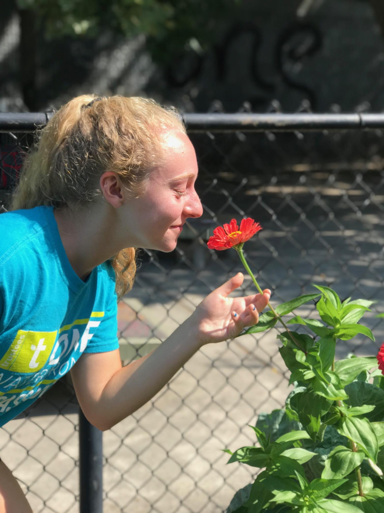 Julie Tassinari taking some time to stop and smell the roses.png