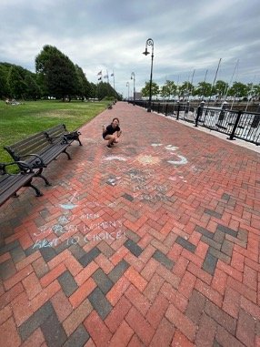 There’s a message on the ground written in chalk about women rights (featuring Jessica and her sandwich.jpg