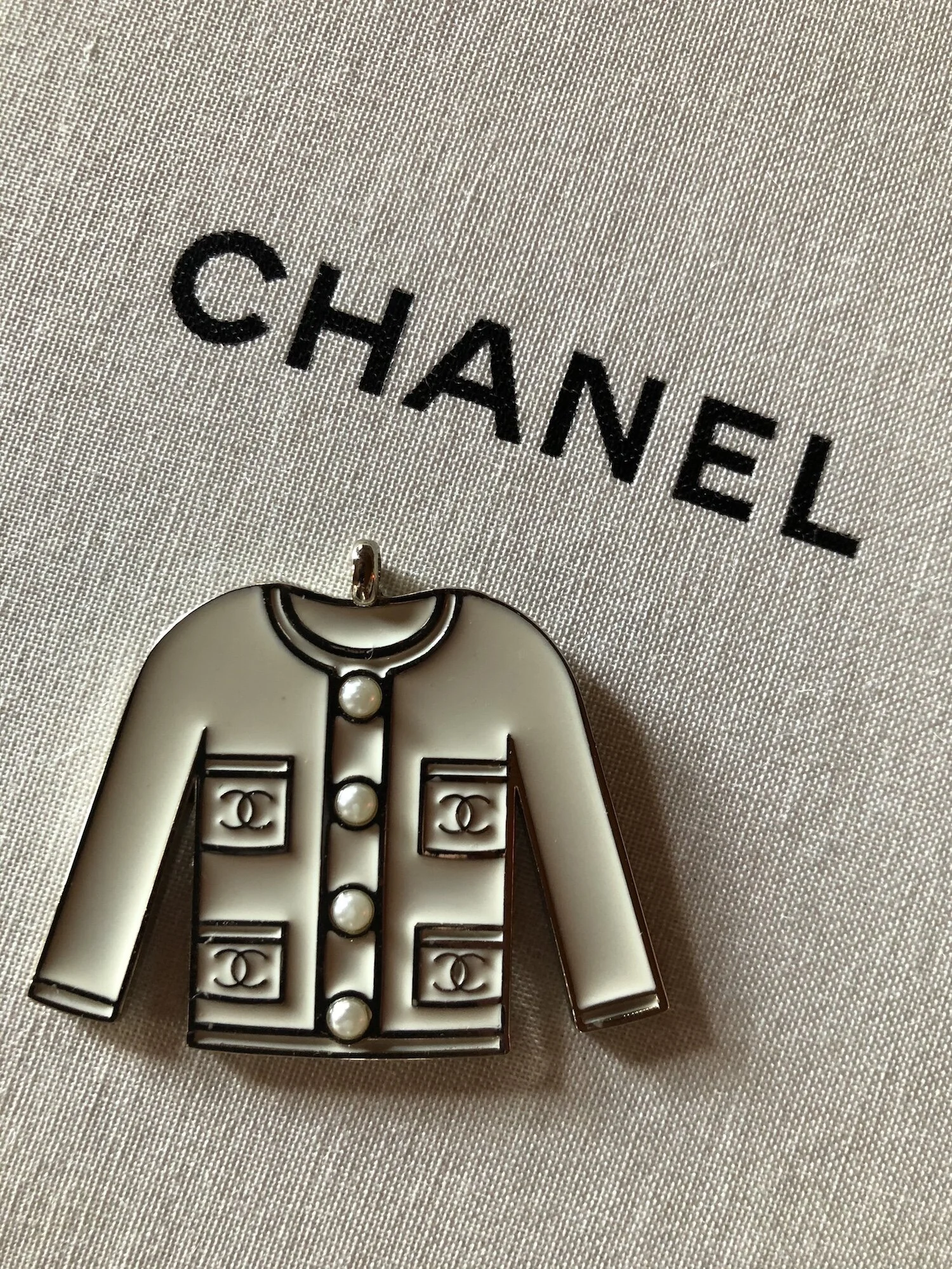 Chanel white jacket charm