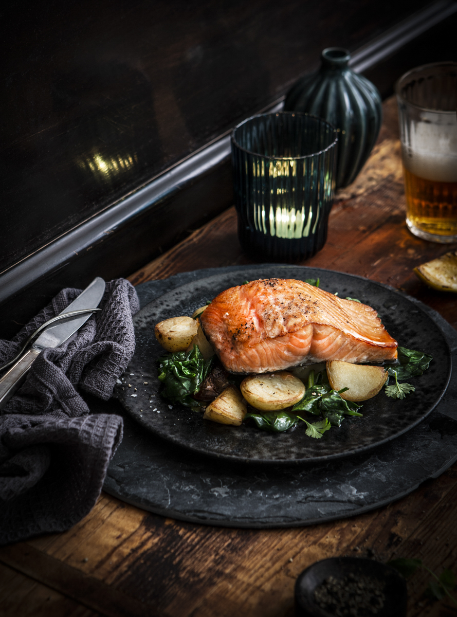 Salmon fillet with potatoes and greens on a plate
