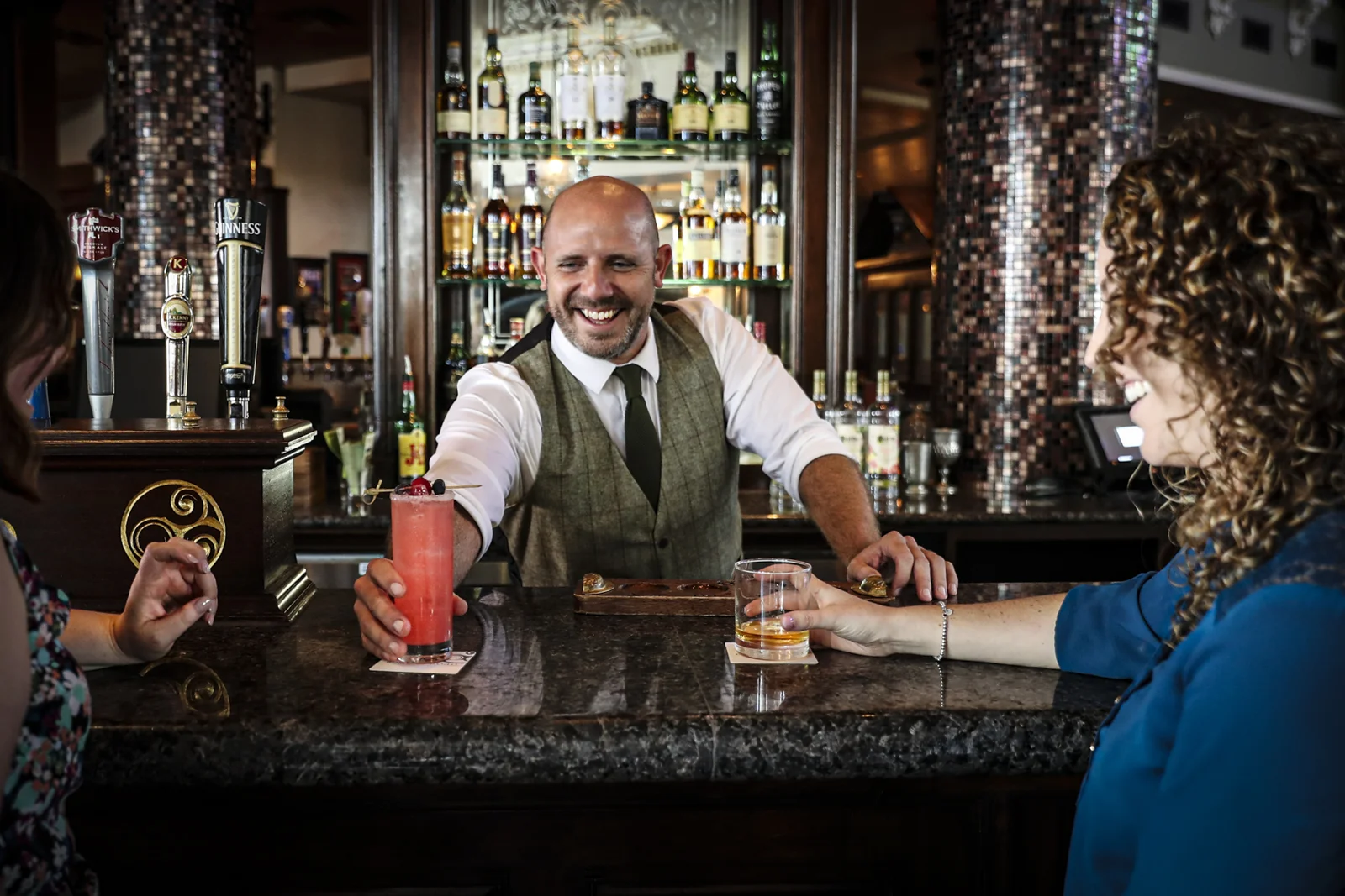 Barman serving a cocktail to a guest