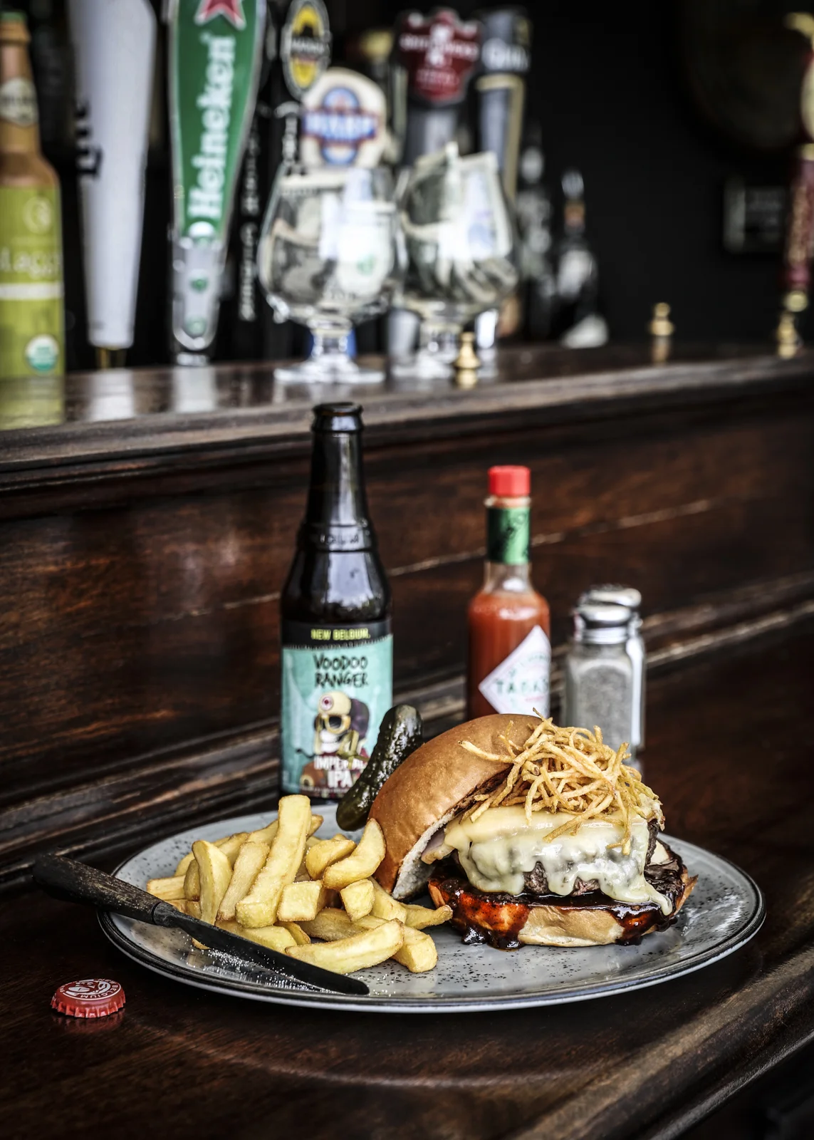 Plate of burger and chips and a beer
