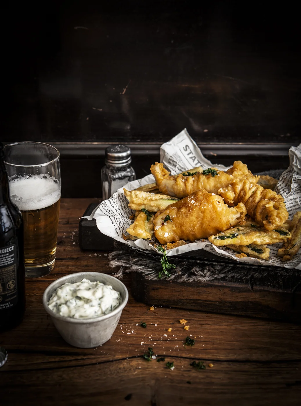Fish and Chips on a plate with beer and dip
