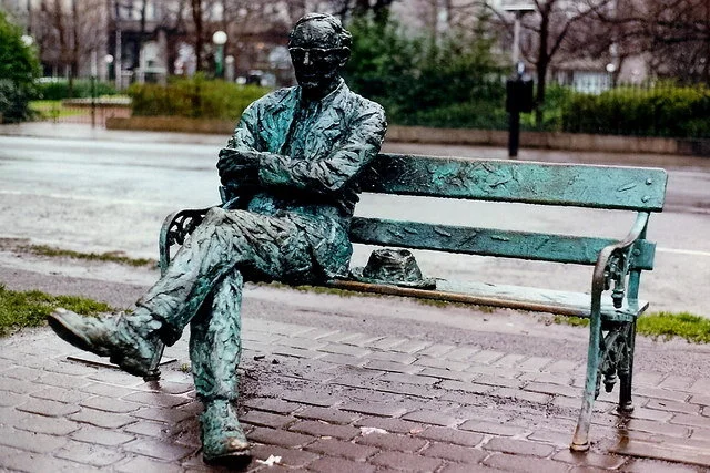 Sculpture of Poet Patrick Kavanagh sitting on a bench
