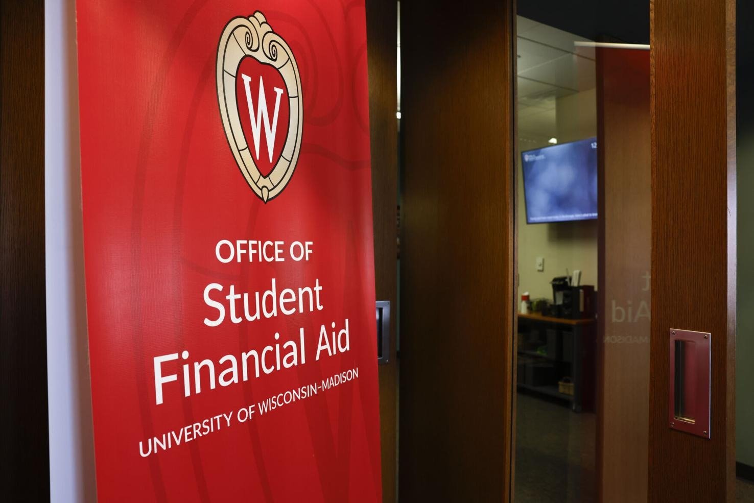 Sign for the Office of Student Financial Aid at the University of Wisconsin-Madison, displaying a red background with university logo and white text.