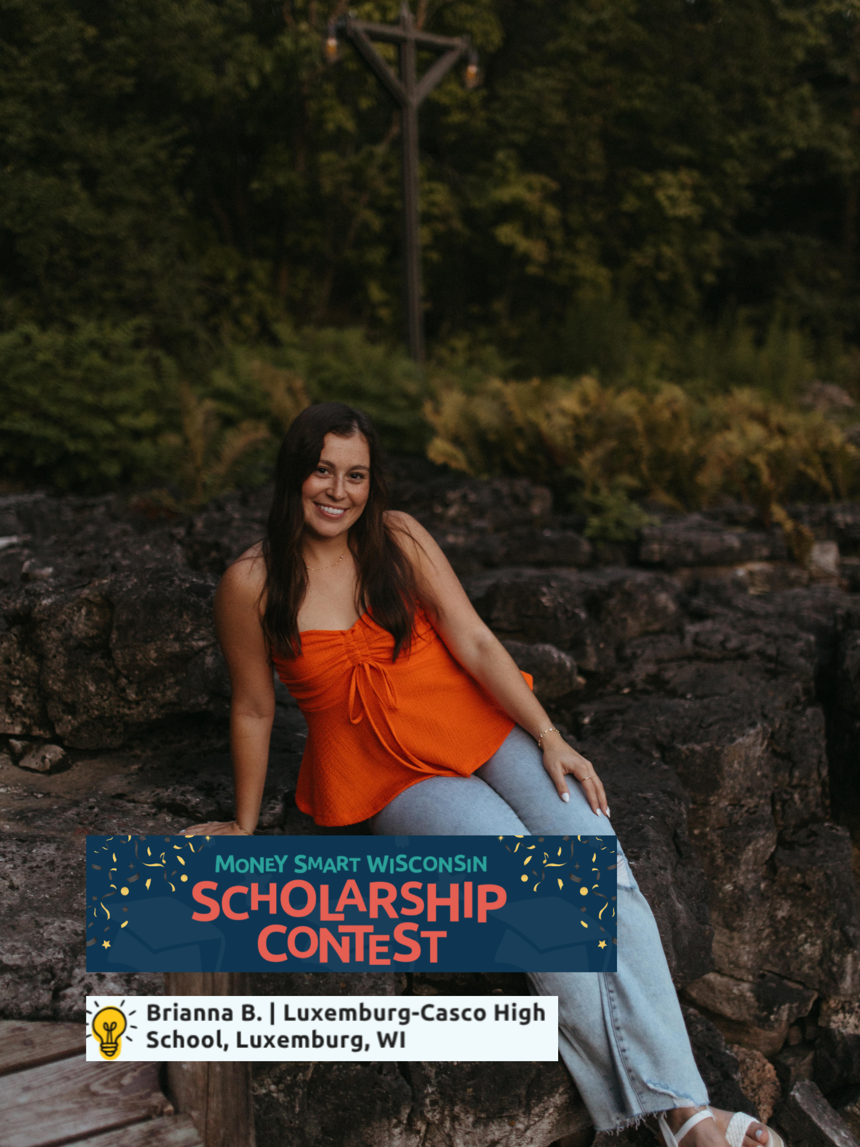 A young woman sitting on rocks outdoors at sunset, smiling, wearing an orange top and light-colored jeans, with trees and a lamppost in the background. There is a banner at the bottom for a scholarship contest hosted by Brianna B. from Luxemburg-Casco High School, Luxemburg, WI.