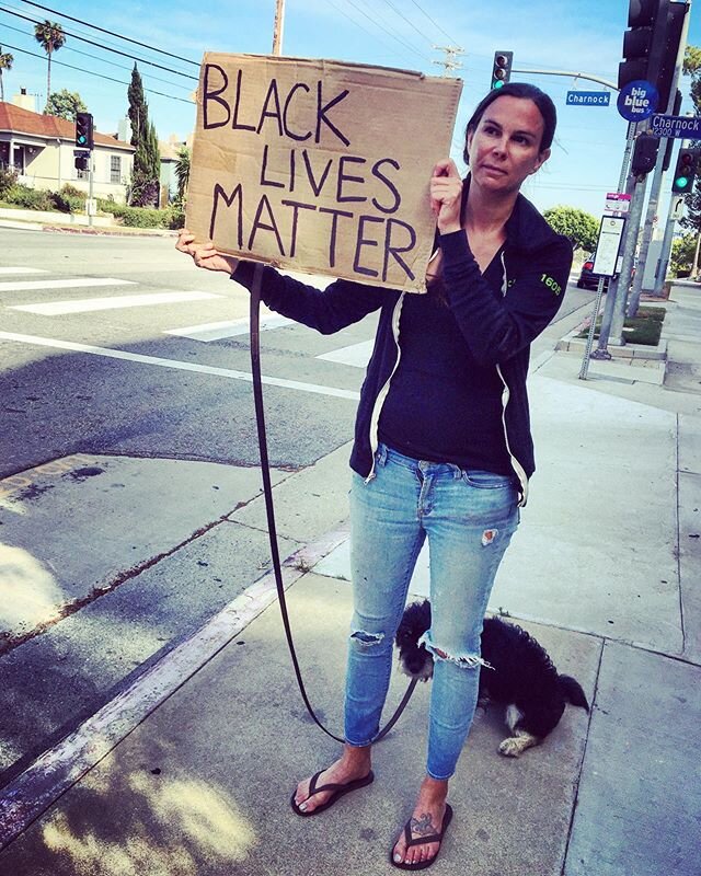 The lone protestor... she left the demonstration in Santa Monica when things went south and is making her stand on Centinela Ave, just her and her dog. Lots of honks of support from passing cars. #blm #justiceforgeorgefloyd #openyoureyes #blacklivesm