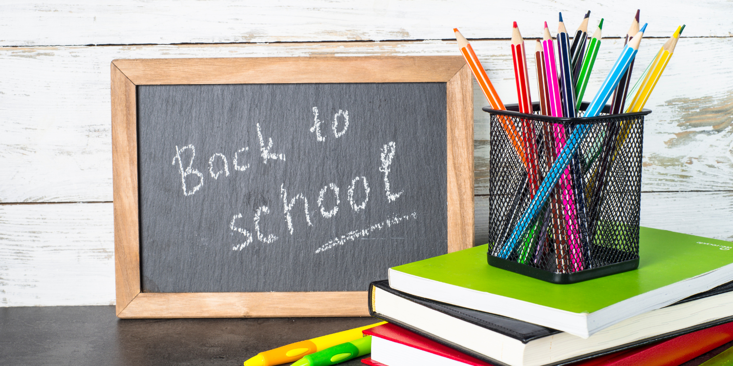 back to school sign with colored pencils next to it
