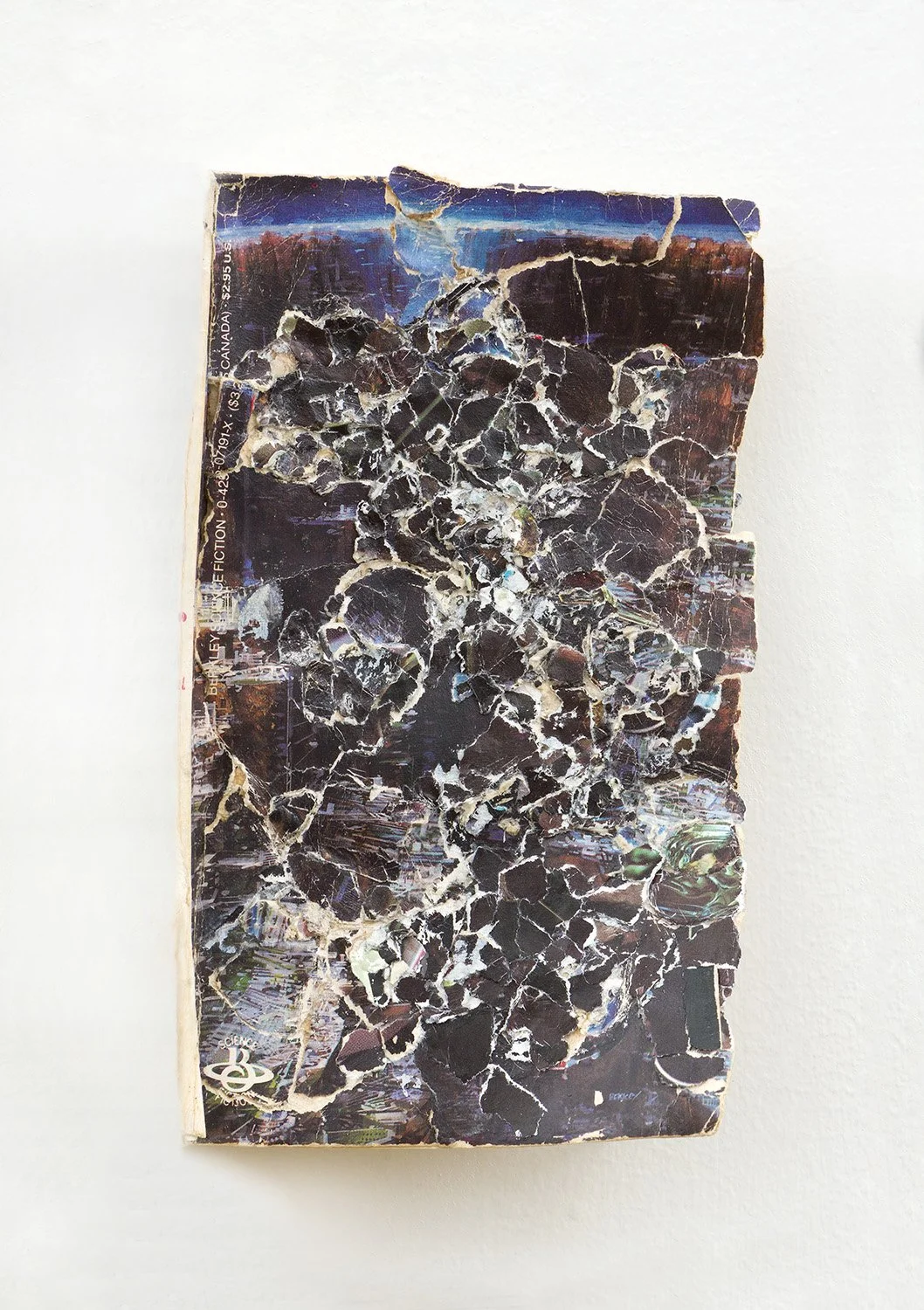 Groupmind , 2022, Collage/decollage on paperback book from Portland, OR,  7 x 5.5 x 1.75”