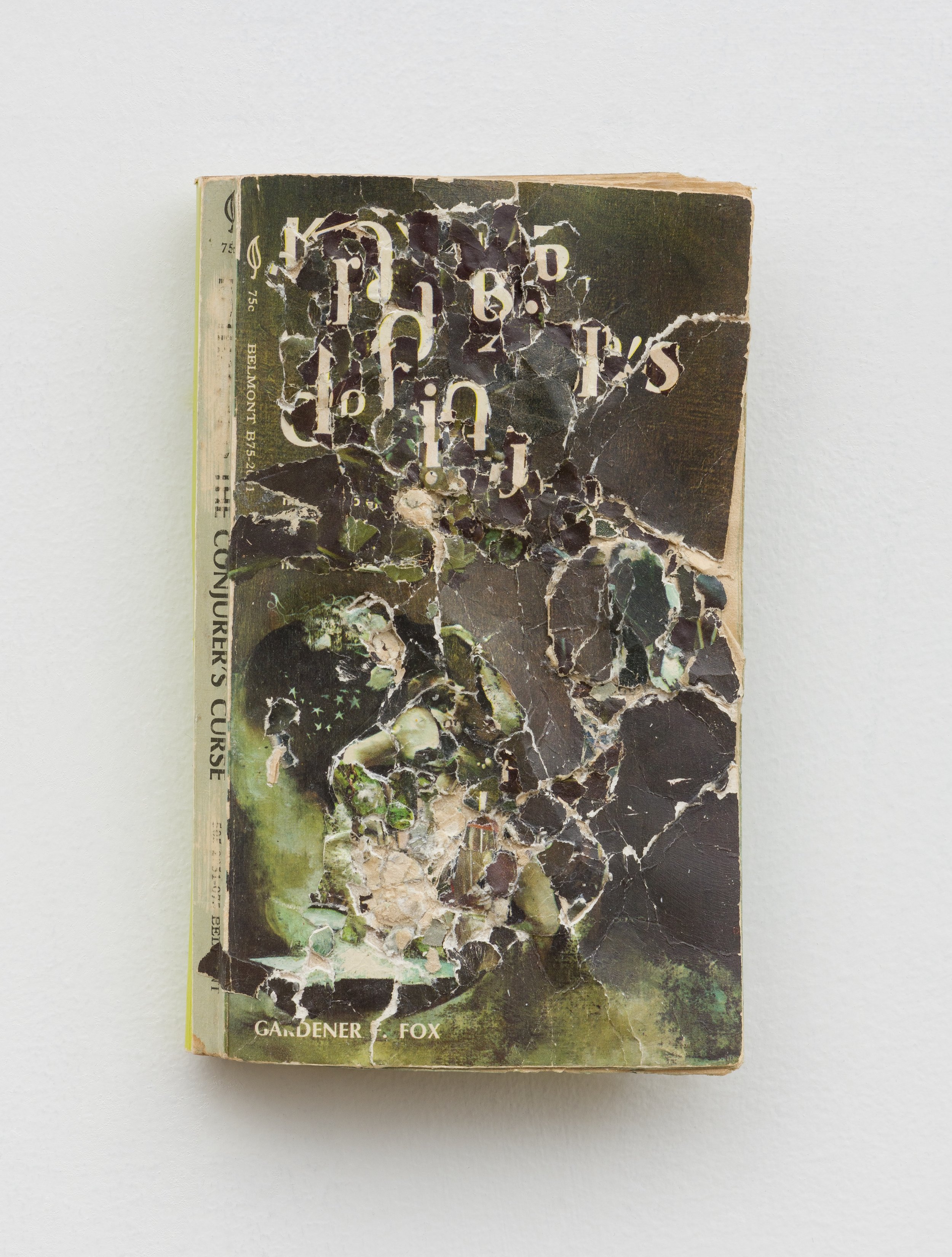 The Conjurer's Curse , 2024, Collage/decollage on paperback book, 7 x 4.25 x .5"