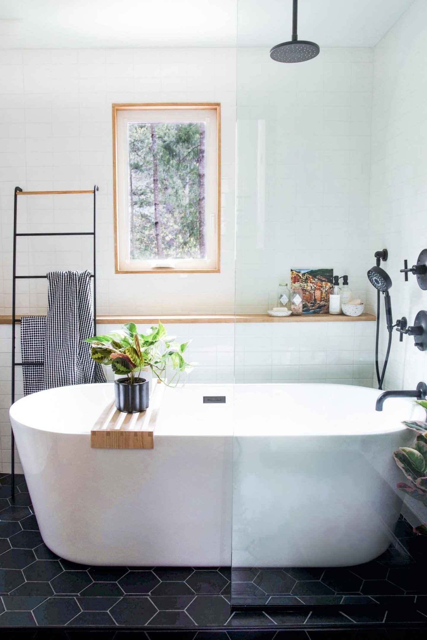 the b&amp;w bathroom at project riverhouse was a sad beige space that lacked a functional layout.  It also included the washer &amp; dryer for the home but with only two bathrooms, those appliances got the boot. 

the revised layout created a focal p