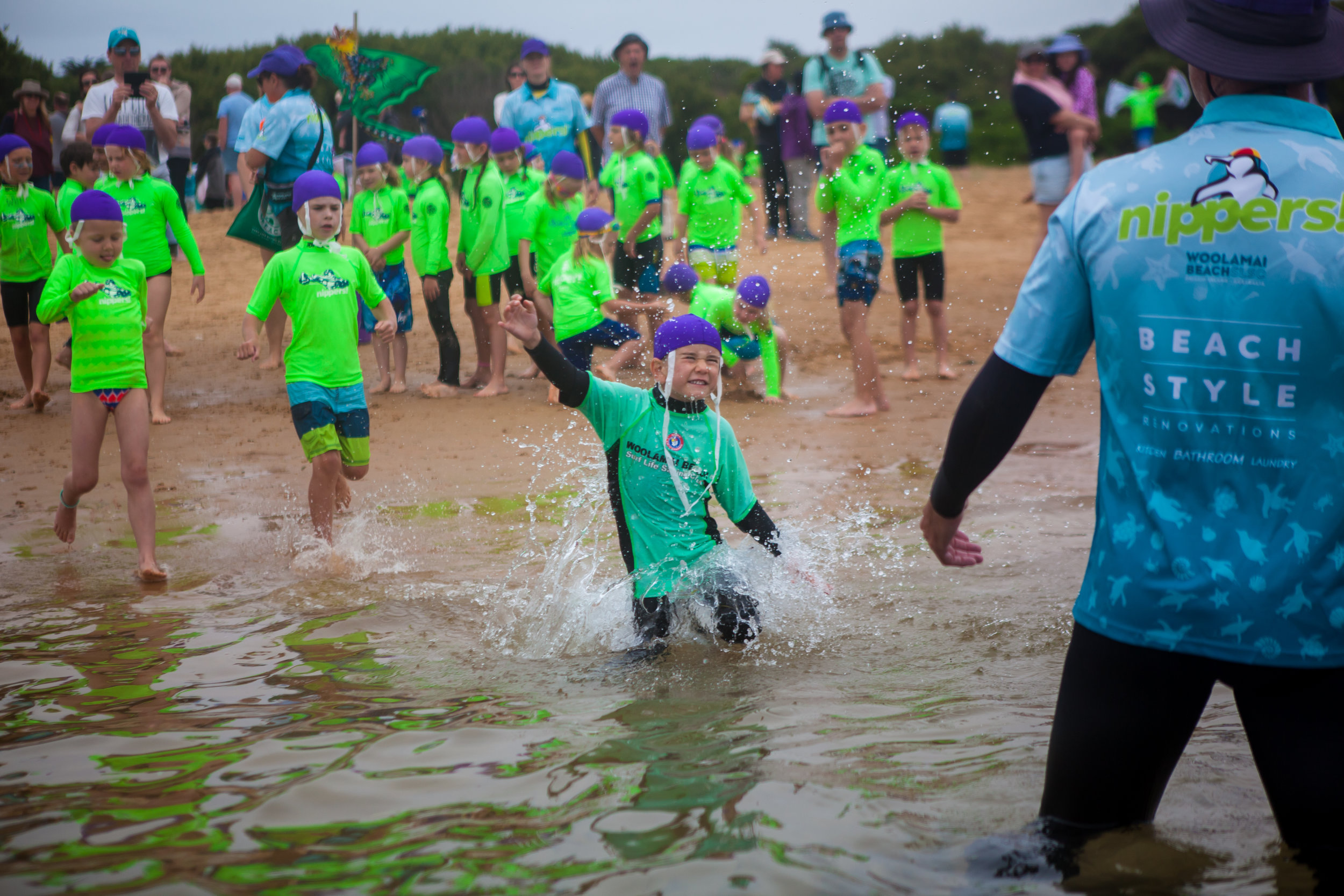 Purple caps running into water plus sponsors Beach Style logo copy 2.jpg