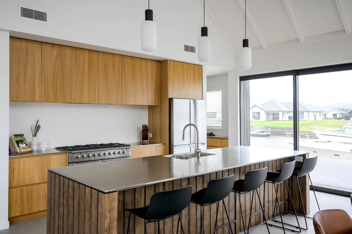 Marsden Cove kitchen.  A raw material palette with warm natural timbers, stainless steel and stone to reflect the exterior cladding and bring the outdoors in. 

Interior Design by @vue_concepts_ 
Architecture by @nickrowe.architecture 
Construction b