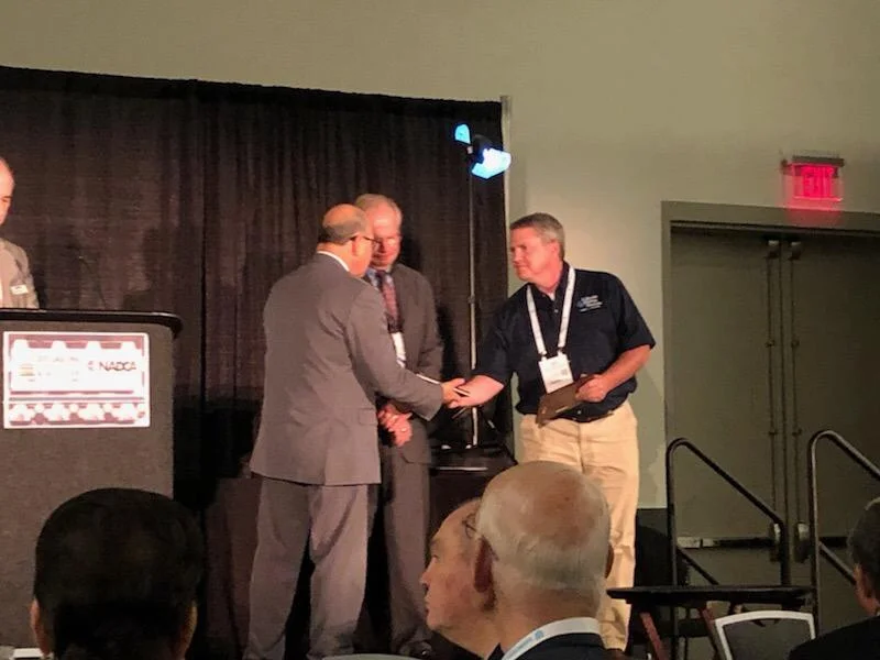Lakeside COO Tony Miller accepts the NADCA design award for a zinc die casting under 6 oz
